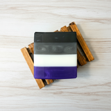 Bar of soap with layered colors on a wooden surface