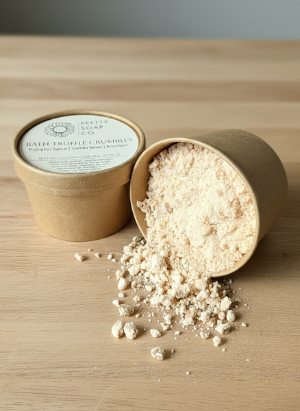 Container of truffle crumbles with 'Pretty Soap Co' branding on a wooden surface