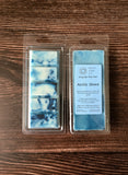 Packaged Arctic Shore wax melts on a wooden surface