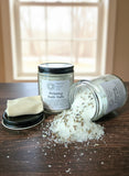 Two jars of bath salts on a wooden surface