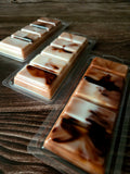Packaged peppermint cocoa wax melt snap bars on a wooden surface