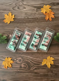Four packages of wax melts on a wooden surface