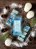 Packaged wax melts labeled 'Winter Wonderland' sitting on a wooden surface