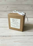 Brown cardboard soap sampler pack with a label on a wooden surface