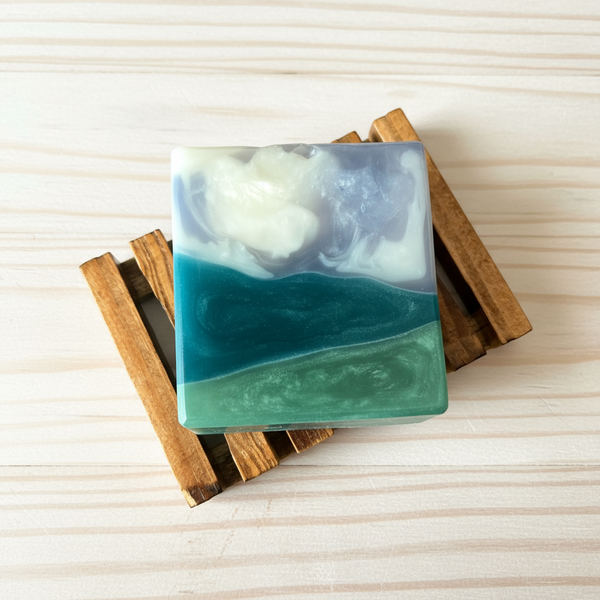Handcrafted soap with a layered design that looks like a valley storm on a wooden block
