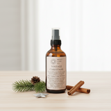 Vintage Christmas-scented spray bottle on a wooden surface